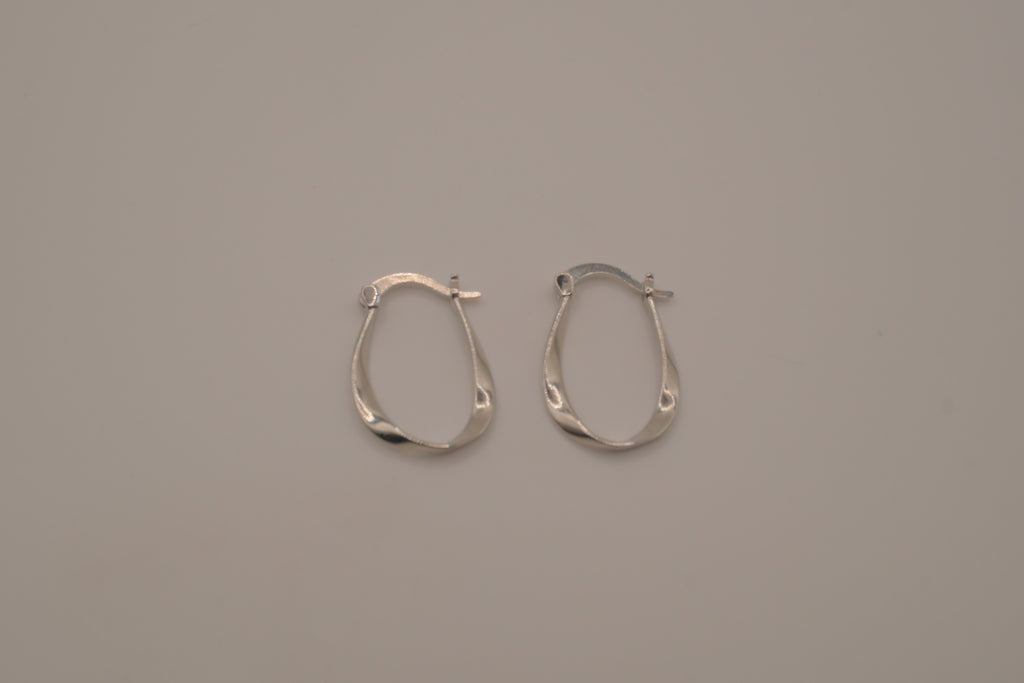 Sculptural, fluid-twisted sterling silver hoop earrings