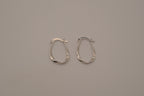 Sculptural, fluid-twisted sterling silver hoop earrings
