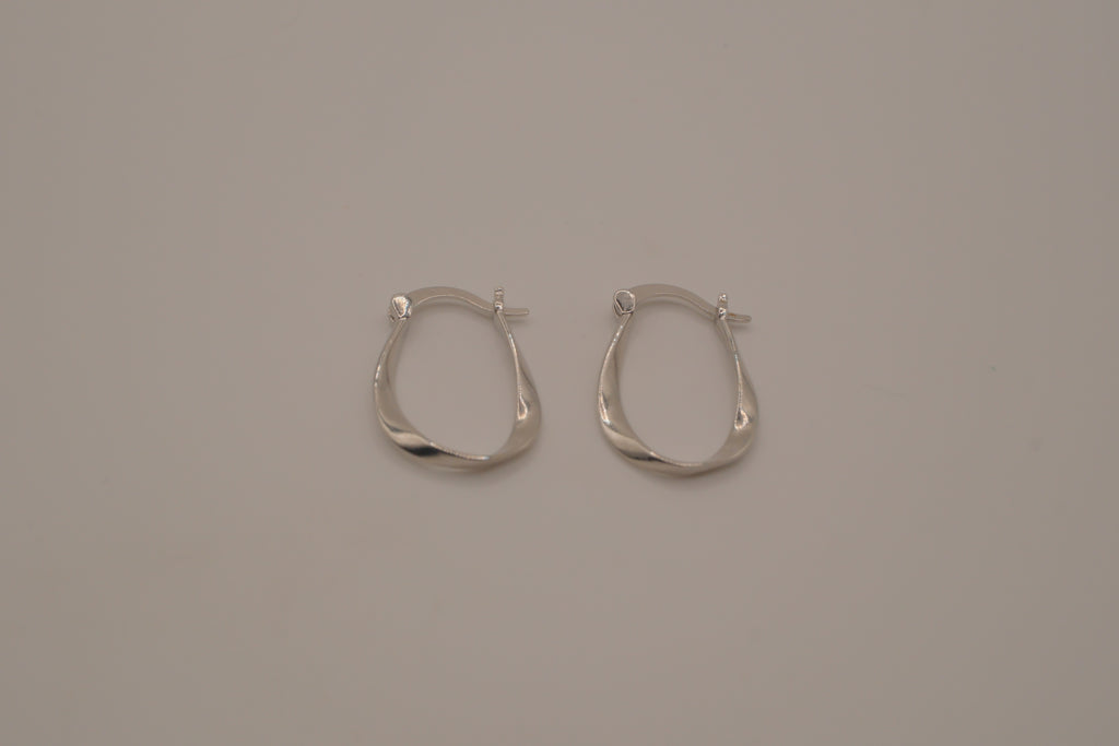 Sculptural, fluid-twisted sterling silver hoop earrings