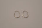 Sculptural, fluid-twisted sterling silver hoop earrings