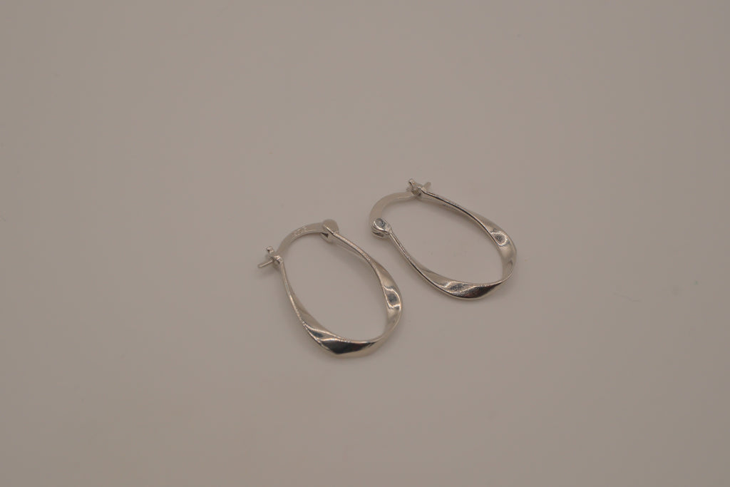 Sculptural, fluid-twisted sterling silver hoop earrings