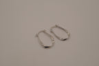 Sculptural, fluid-twisted sterling silver hoop earrings