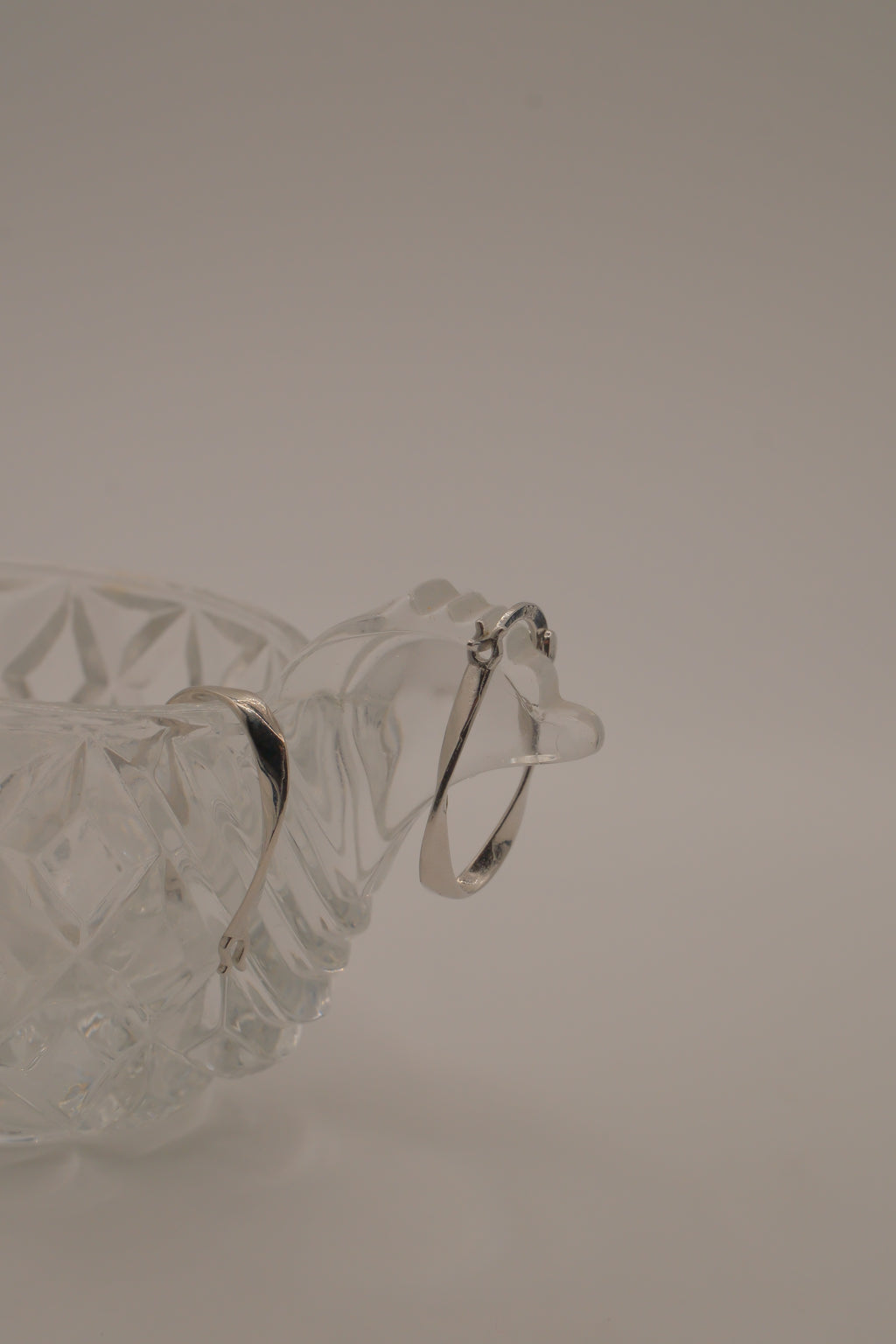 Sculptural, fluid-twisted sterling silver hoop earrings
