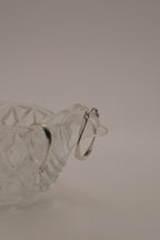 Sculptural, fluid-twisted sterling silver hoop earrings