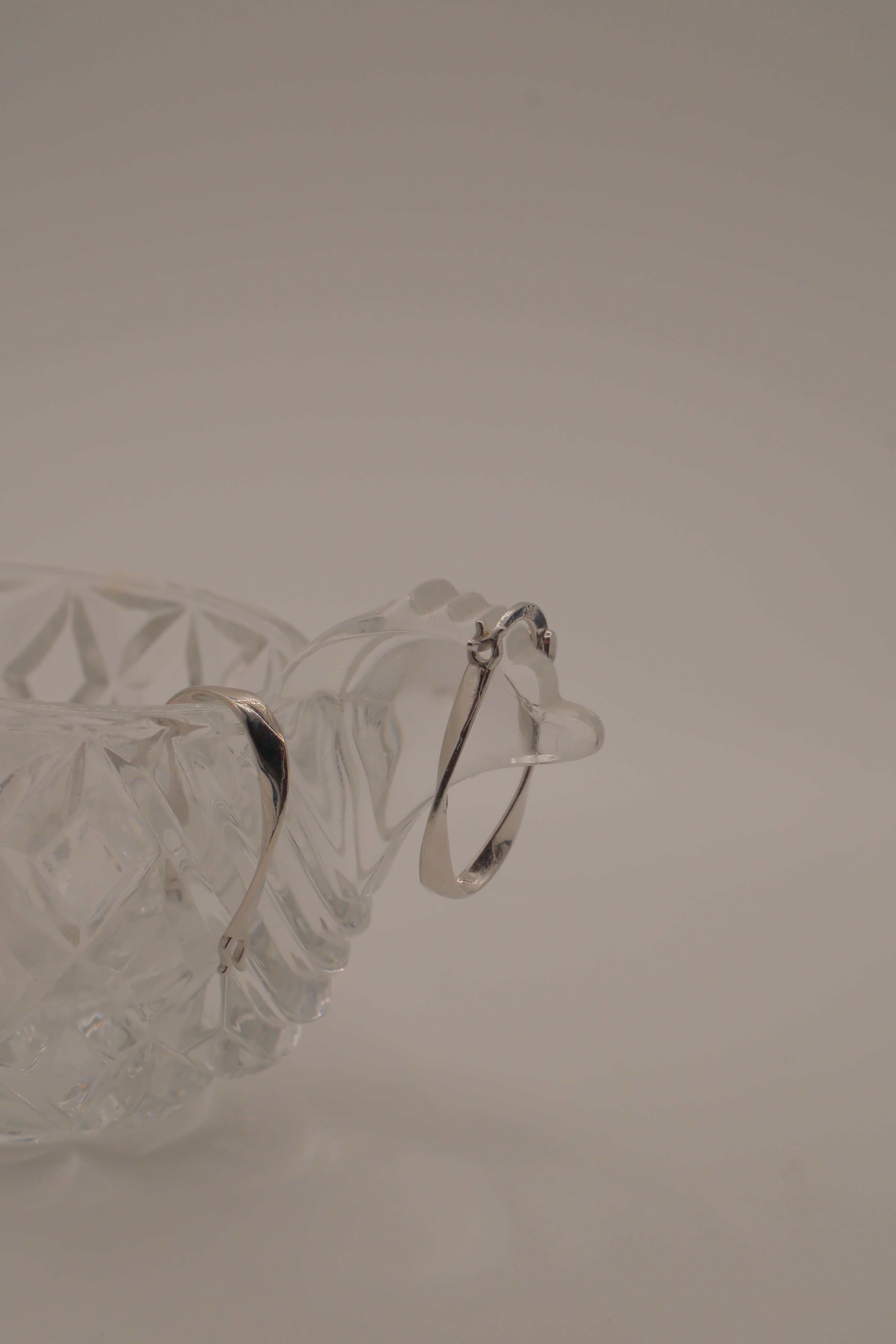 Sculptural, fluid-twisted sterling silver hoop earrings