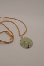 Natural prehnite pendant on leather cord
