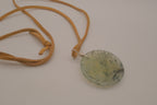 Natural prehnite pendant on leather cord