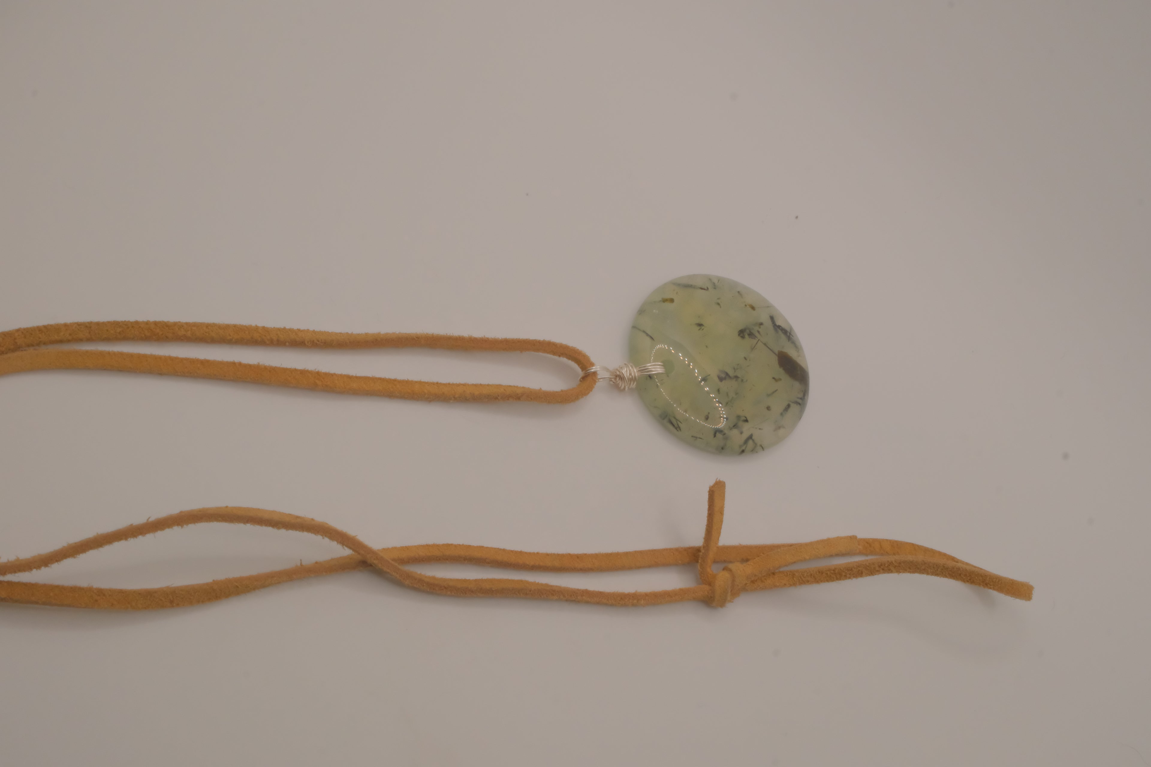 Natural prehnite pendant on leather cord
