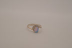 Sterling silver oval opal ring with a curved accent band