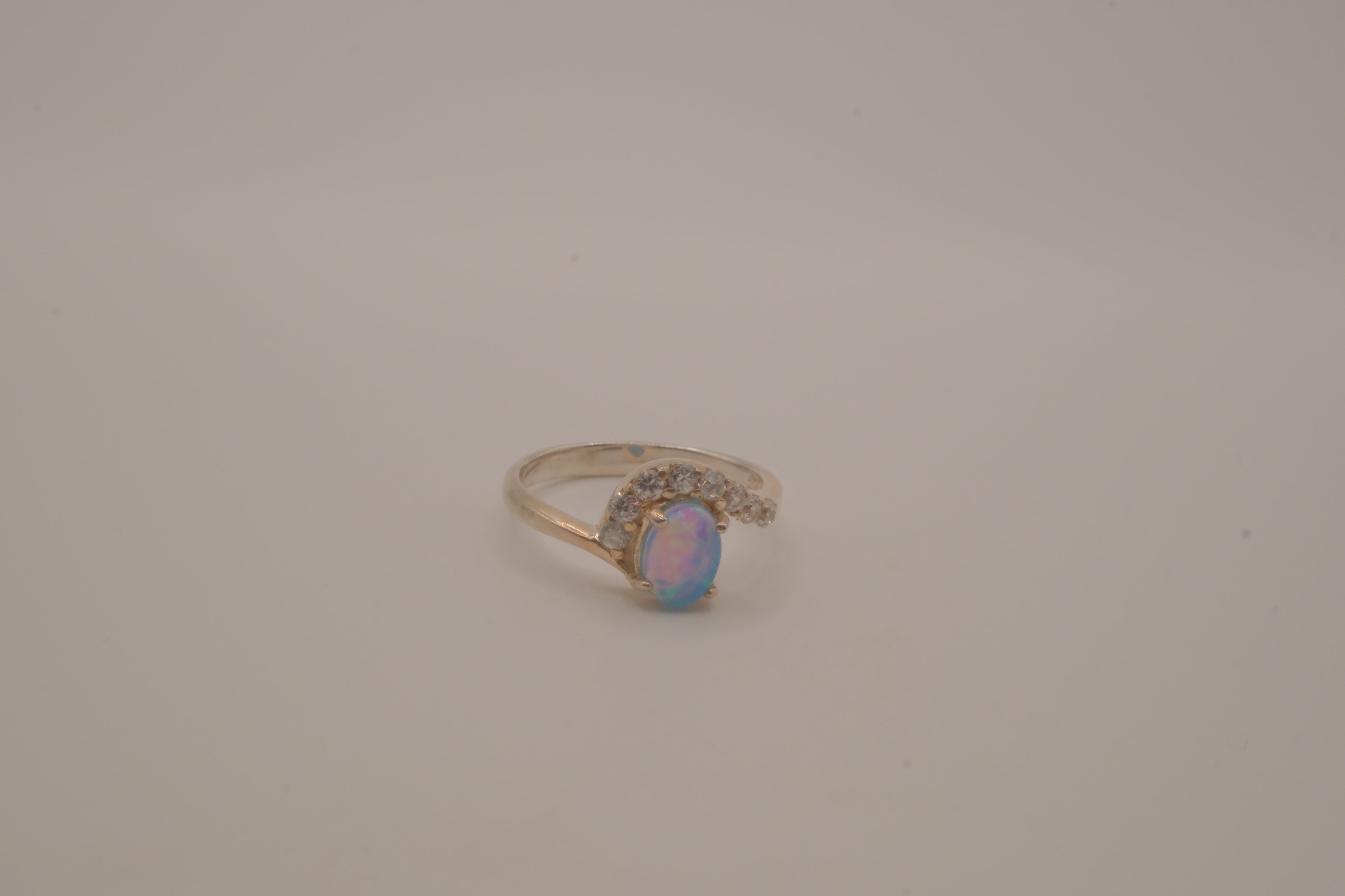 Sterling silver oval opal ring with a curved accent band