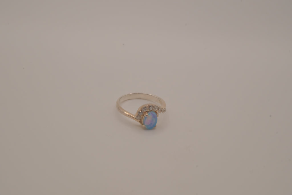Sterling silver oval opal ring with a curved accent band