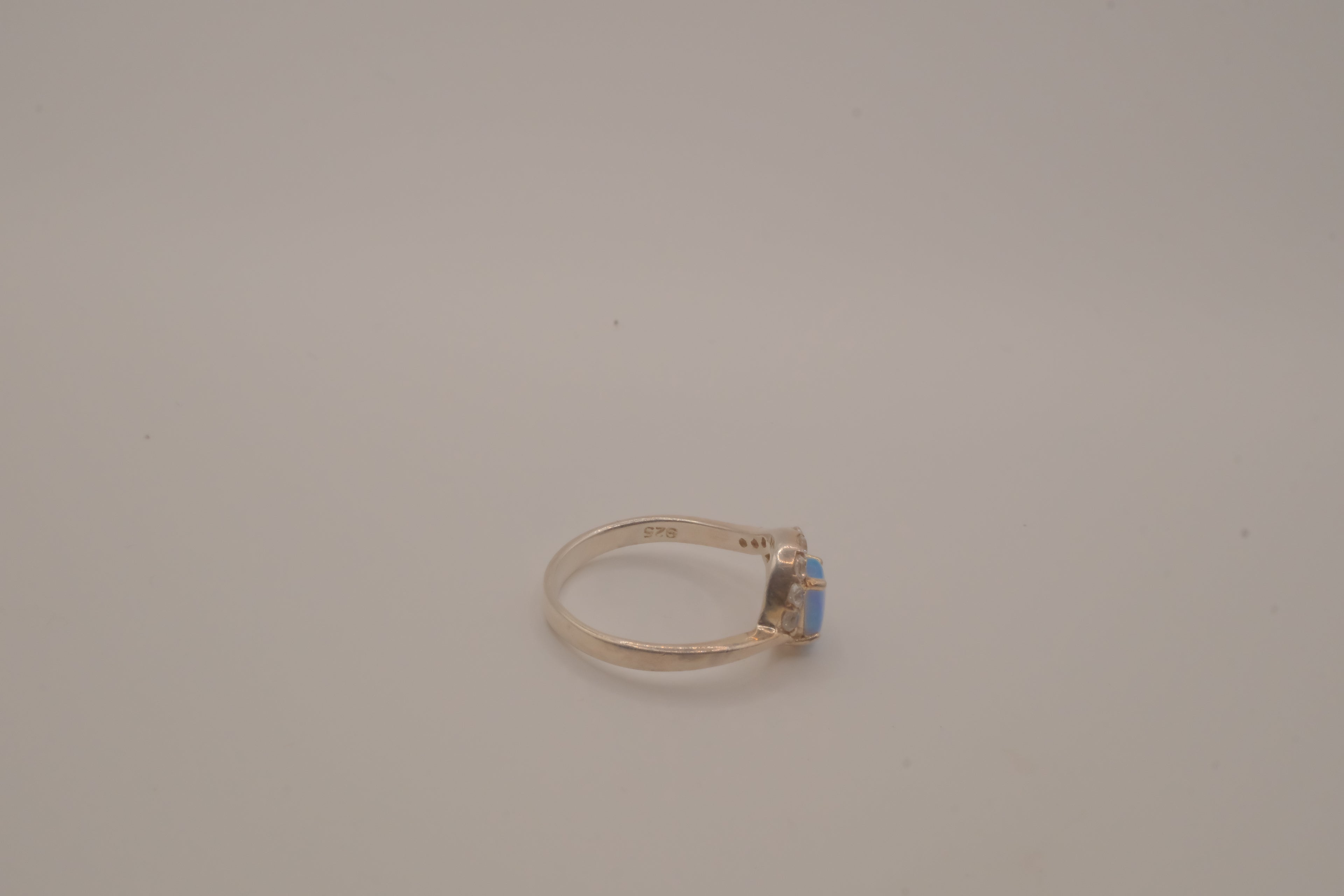 Sterling silver oval opal ring with a curved accent band
