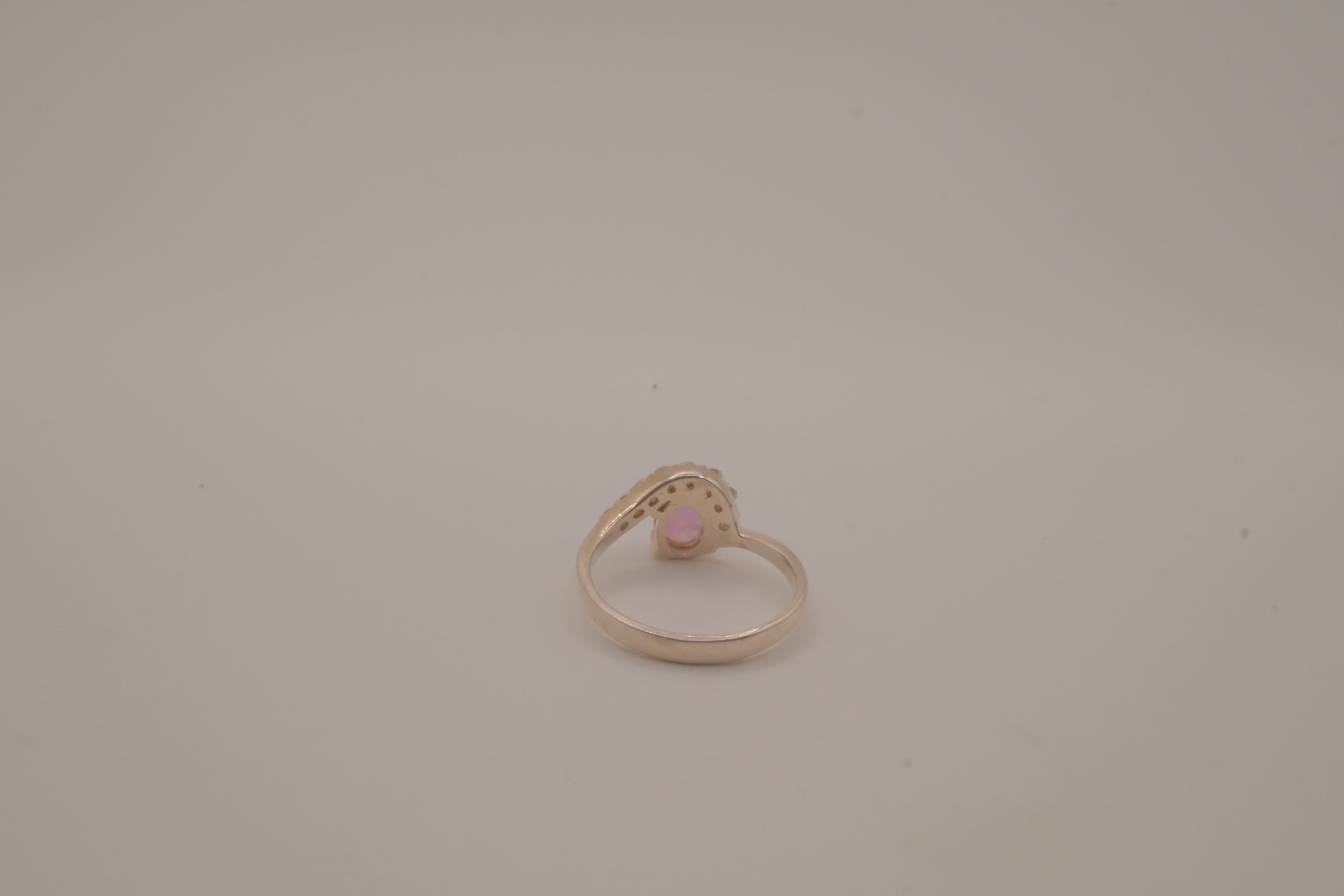 Sterling silver oval opal ring with a curved accent band