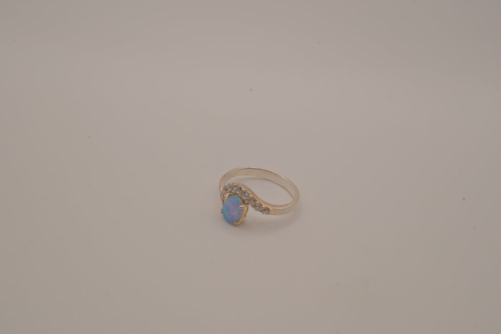 Sterling silver oval opal ring with a curved accent band