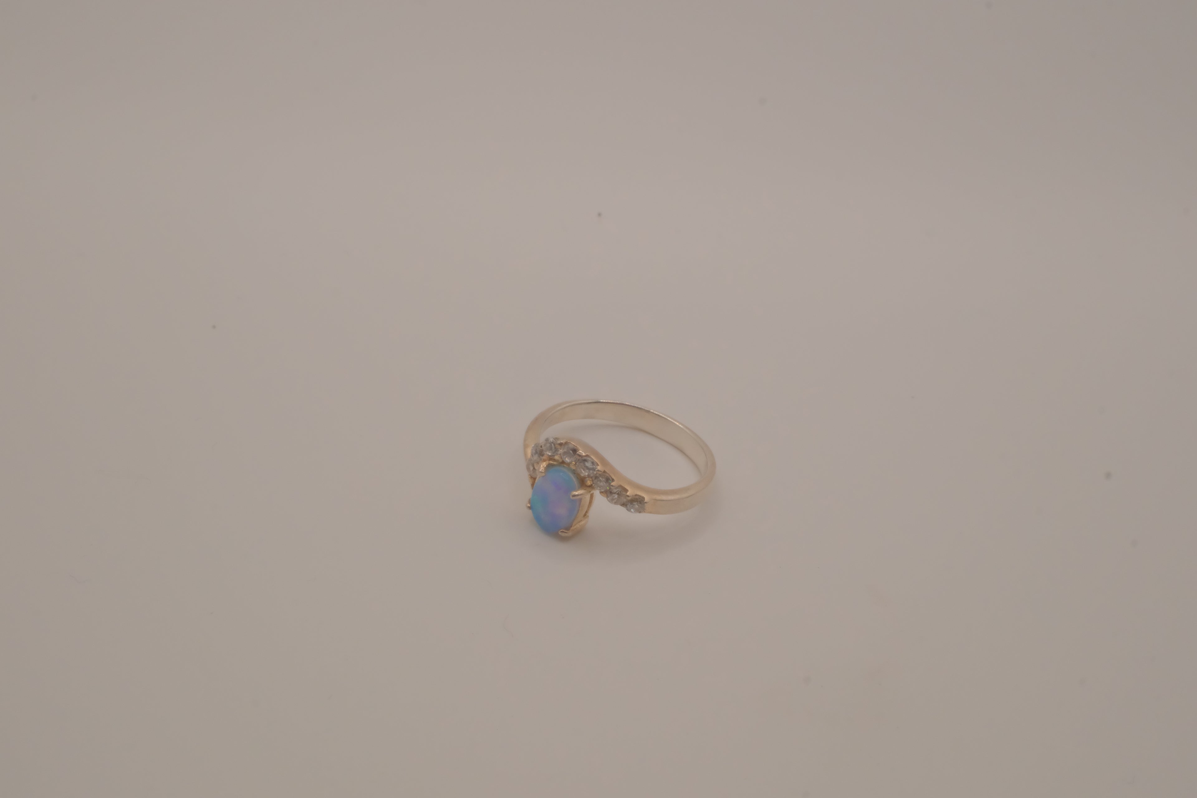 Sterling silver oval opal ring with a curved accent band