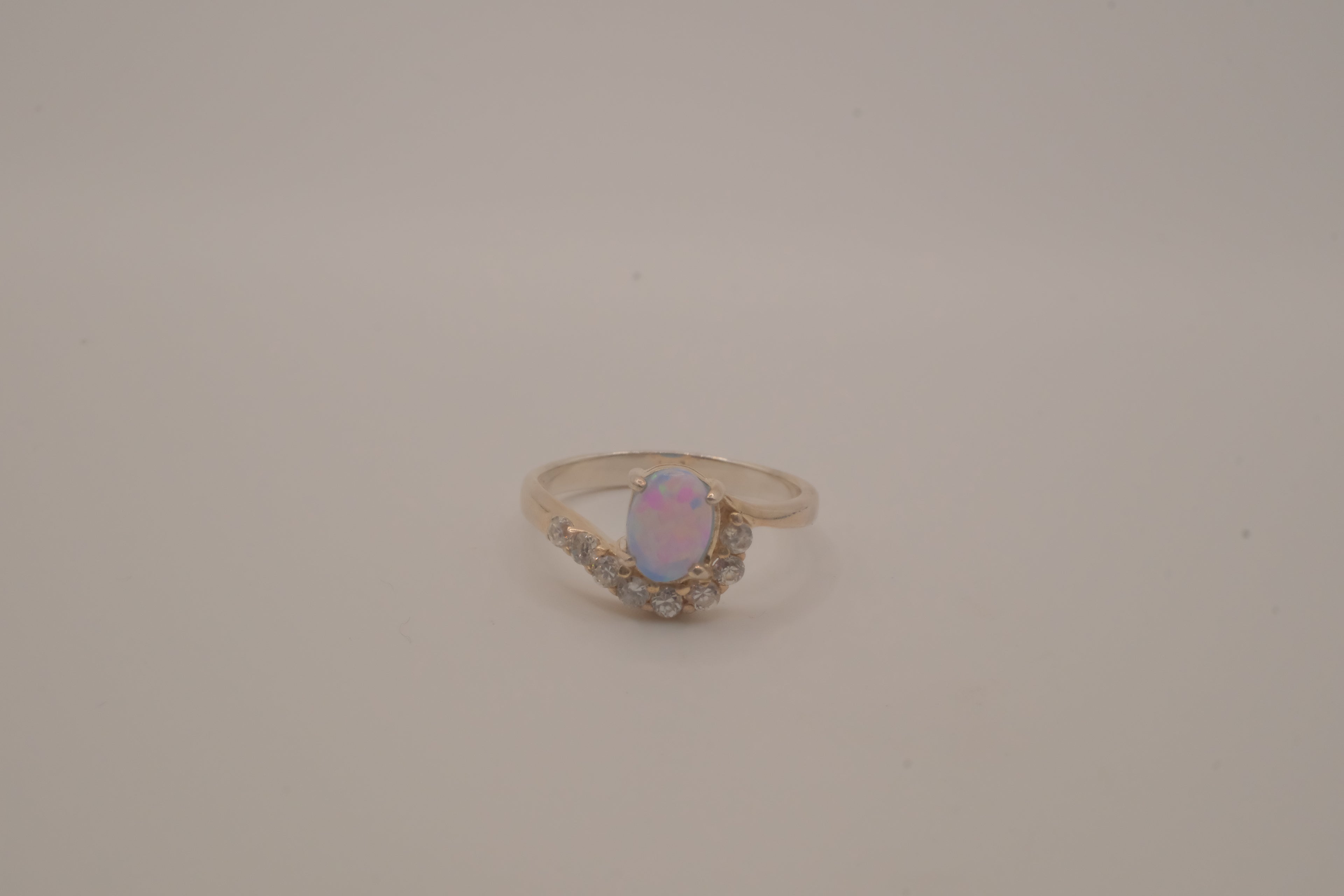 Sterling silver oval opal ring with a curved accent band