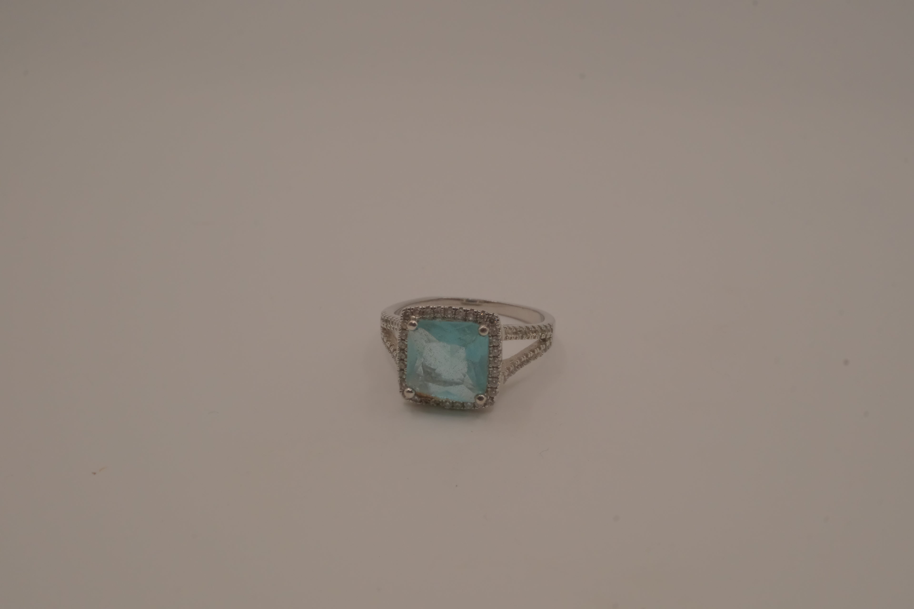 Cushion-cut blue stone halo ring