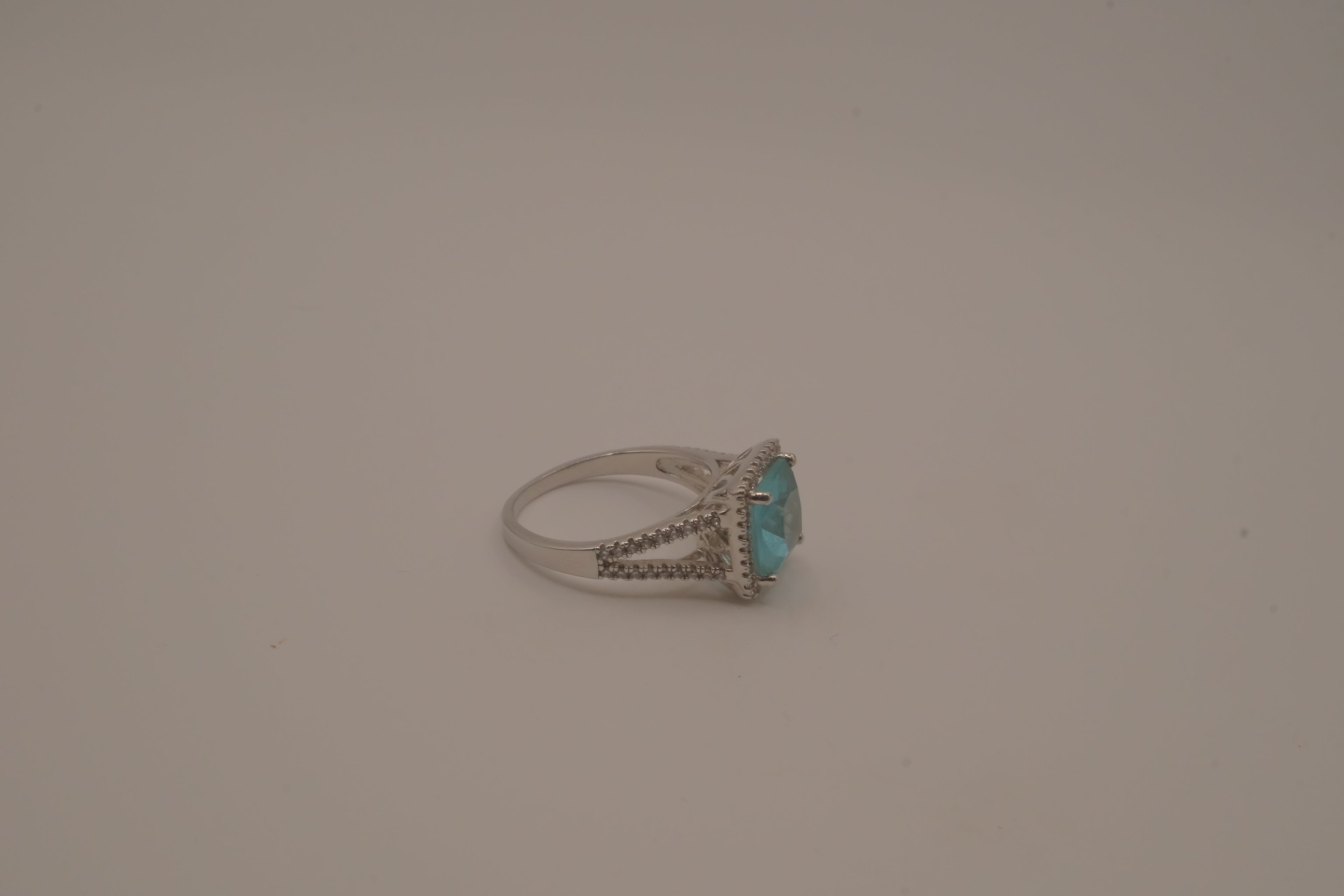 Cushion-cut blue stone halo ring