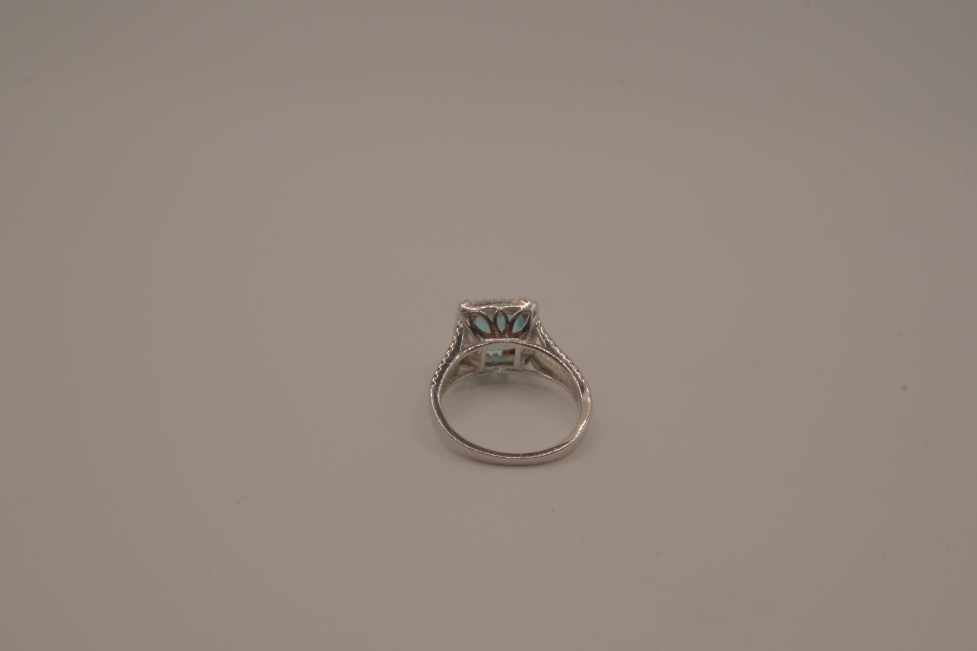 Cushion-cut blue stone halo ring