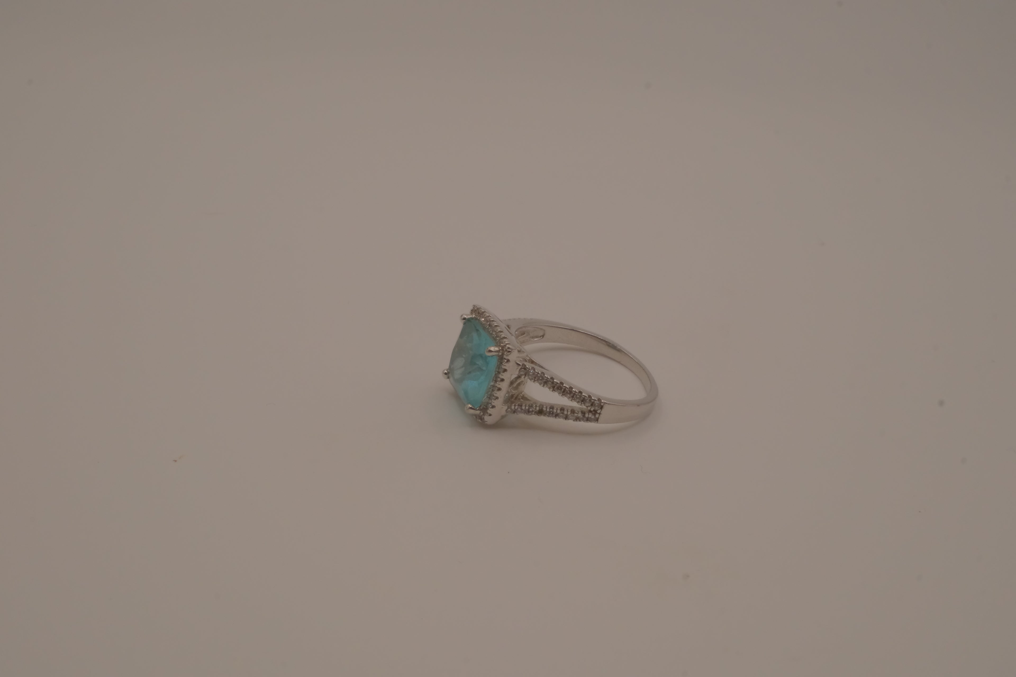 Cushion-cut blue stone halo ring