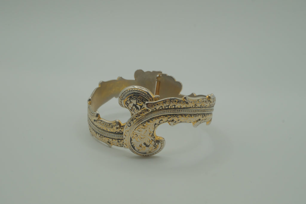 Ornate antique silver and gold-tone bypass clamper bracelet