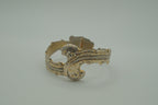 Ornate antique silver and gold-tone bypass clamper bracelet