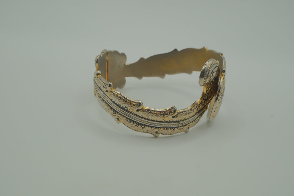 Ornate antique silver and gold-tone bypass clamper bracelet