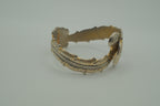 Ornate antique silver and gold-tone bypass clamper bracelet