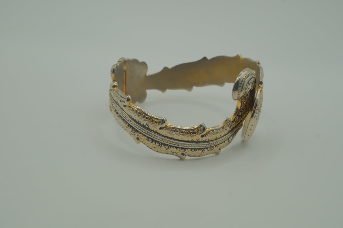 Ornate antique silver and gold-tone bypass clamper bracelet