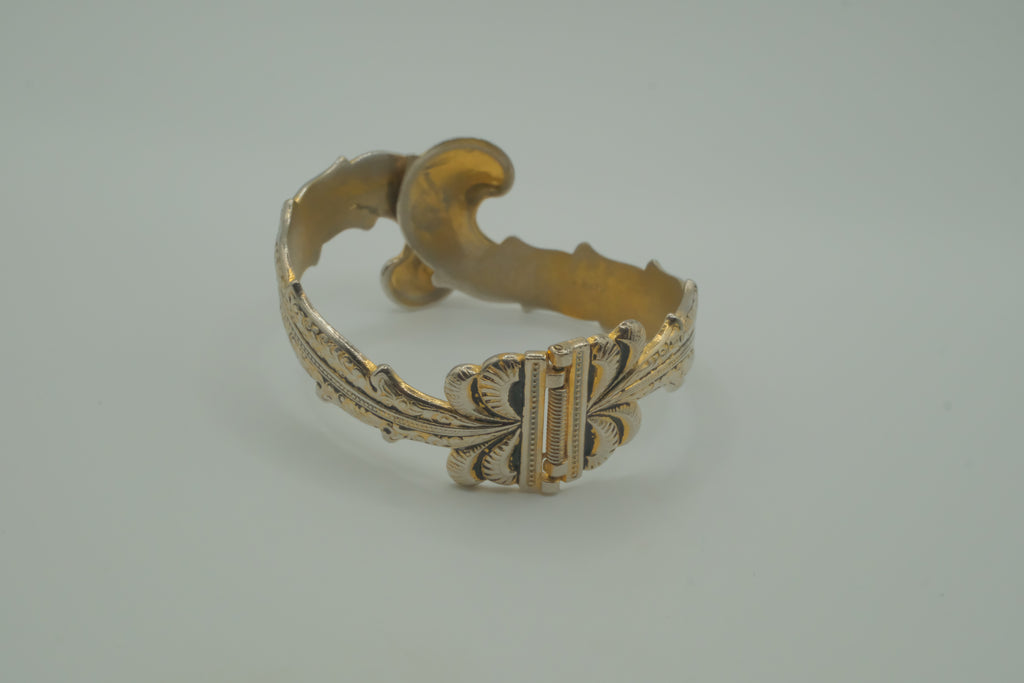 Ornate antique silver and gold-tone bypass clamper bracelet