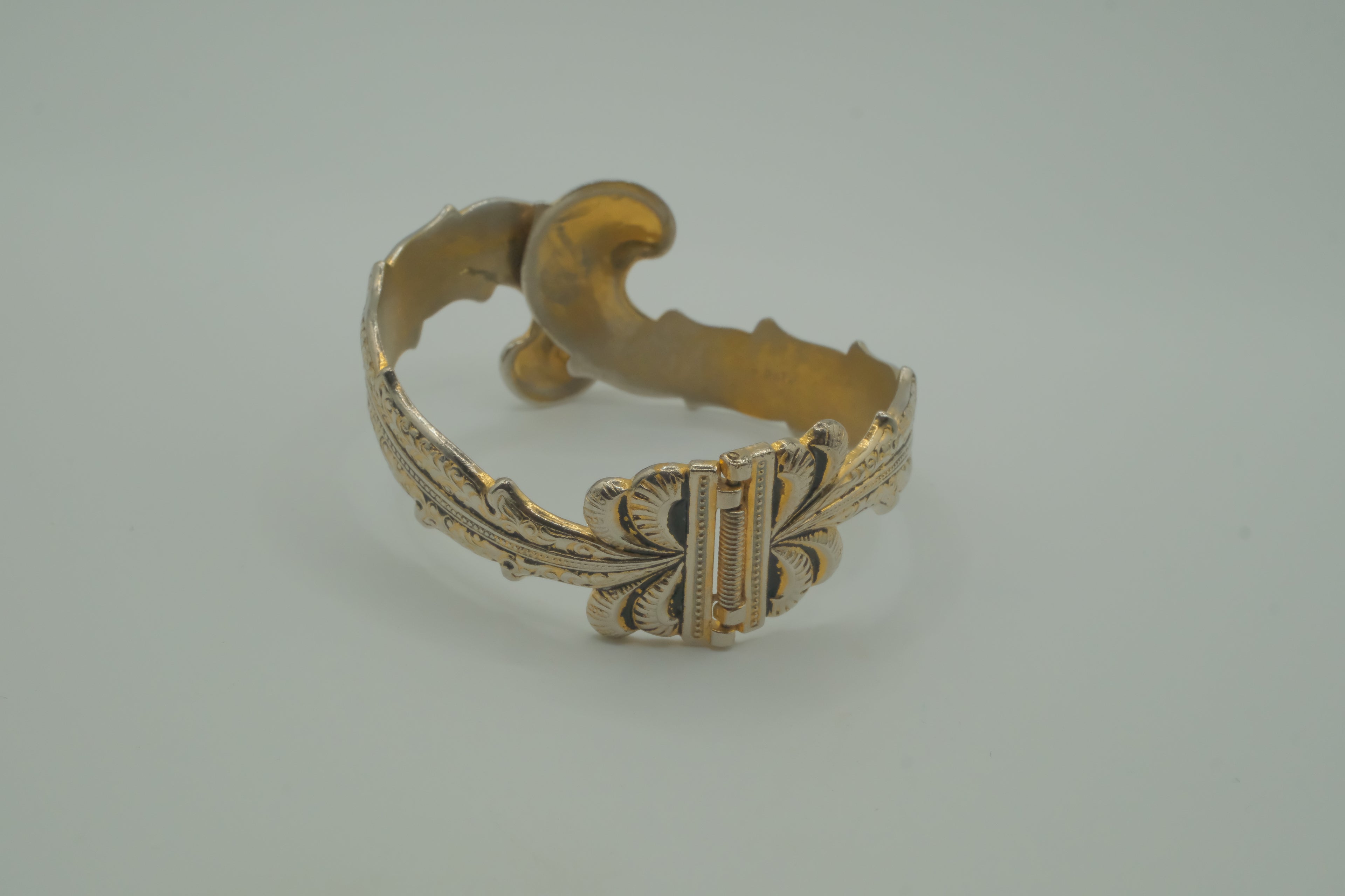 Ornate antique silver and gold-tone bypass clamper bracelet