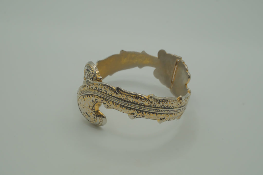Ornate antique silver and gold-tone bypass clamper bracelet