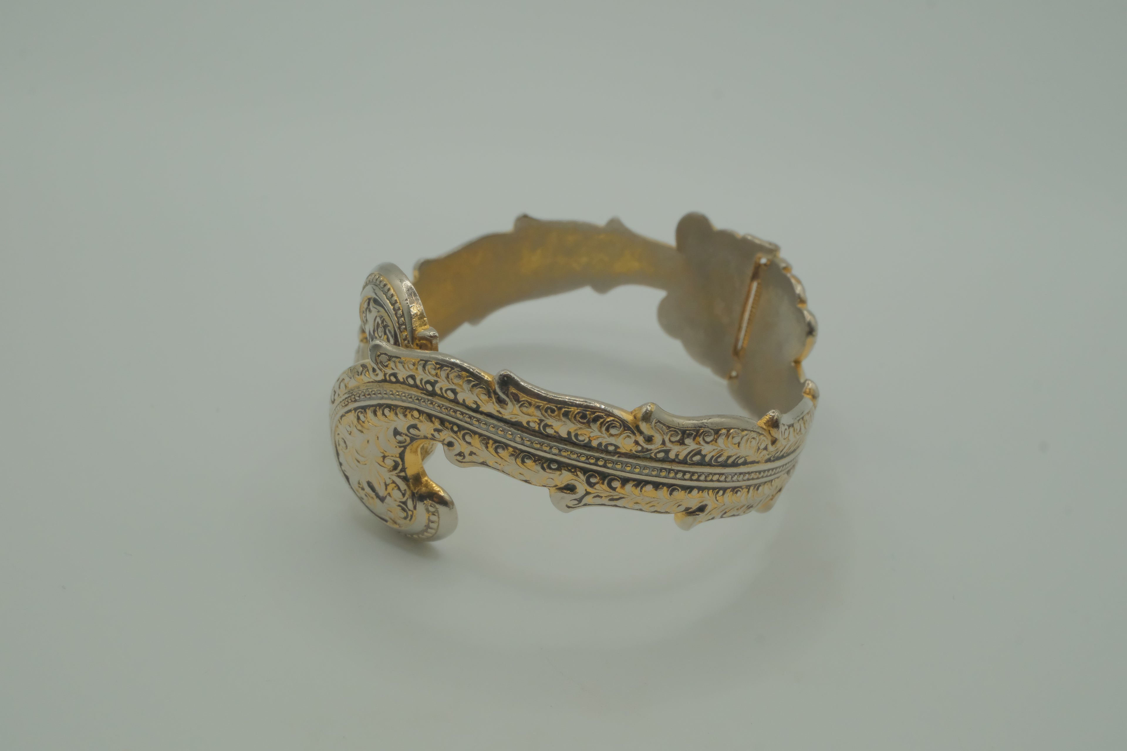 Ornate antique silver and gold-tone bypass clamper bracelet