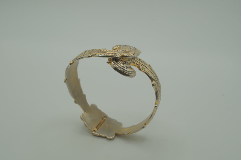 Ornate antique silver and gold-tone bypass clamper bracelet