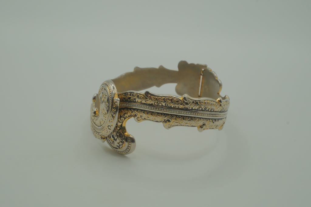 Ornate antique silver and gold-tone bypass clamper bracelet
