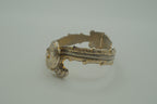 Ornate antique silver and gold-tone bypass clamper bracelet