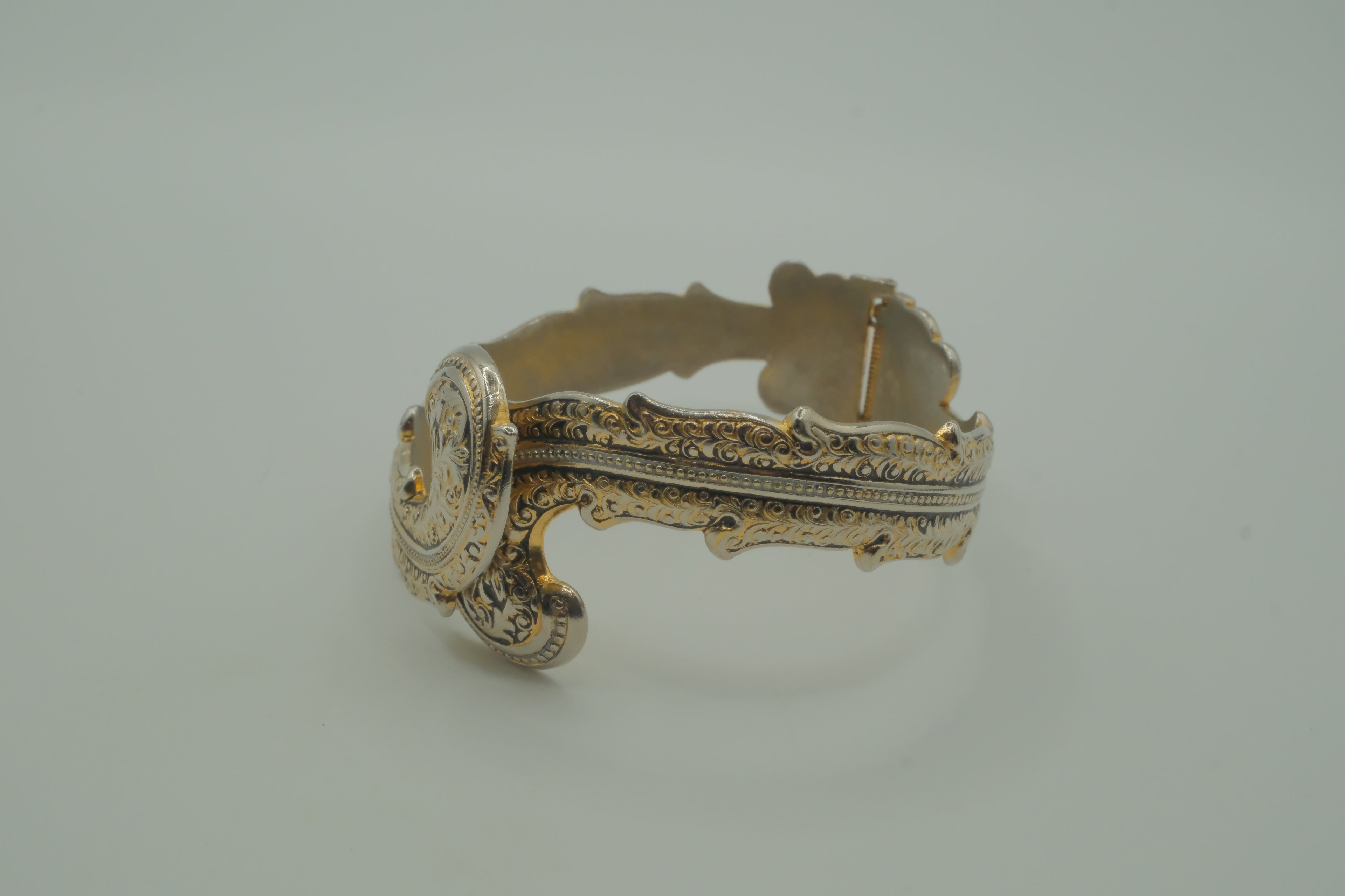 Ornate antique silver and gold-tone bypass clamper bracelet