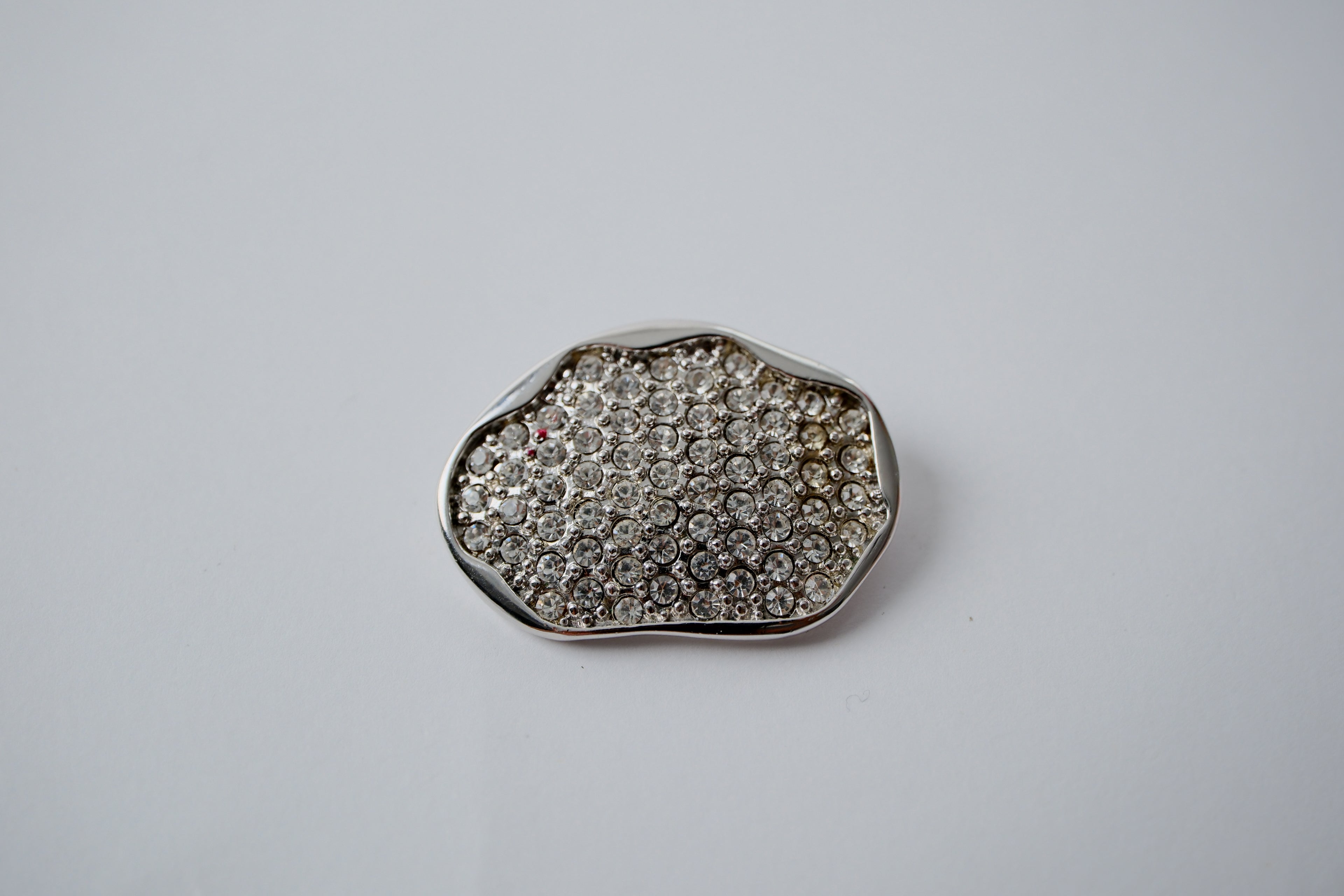 Silver toned Brooch with a cluster of clear rhinestones