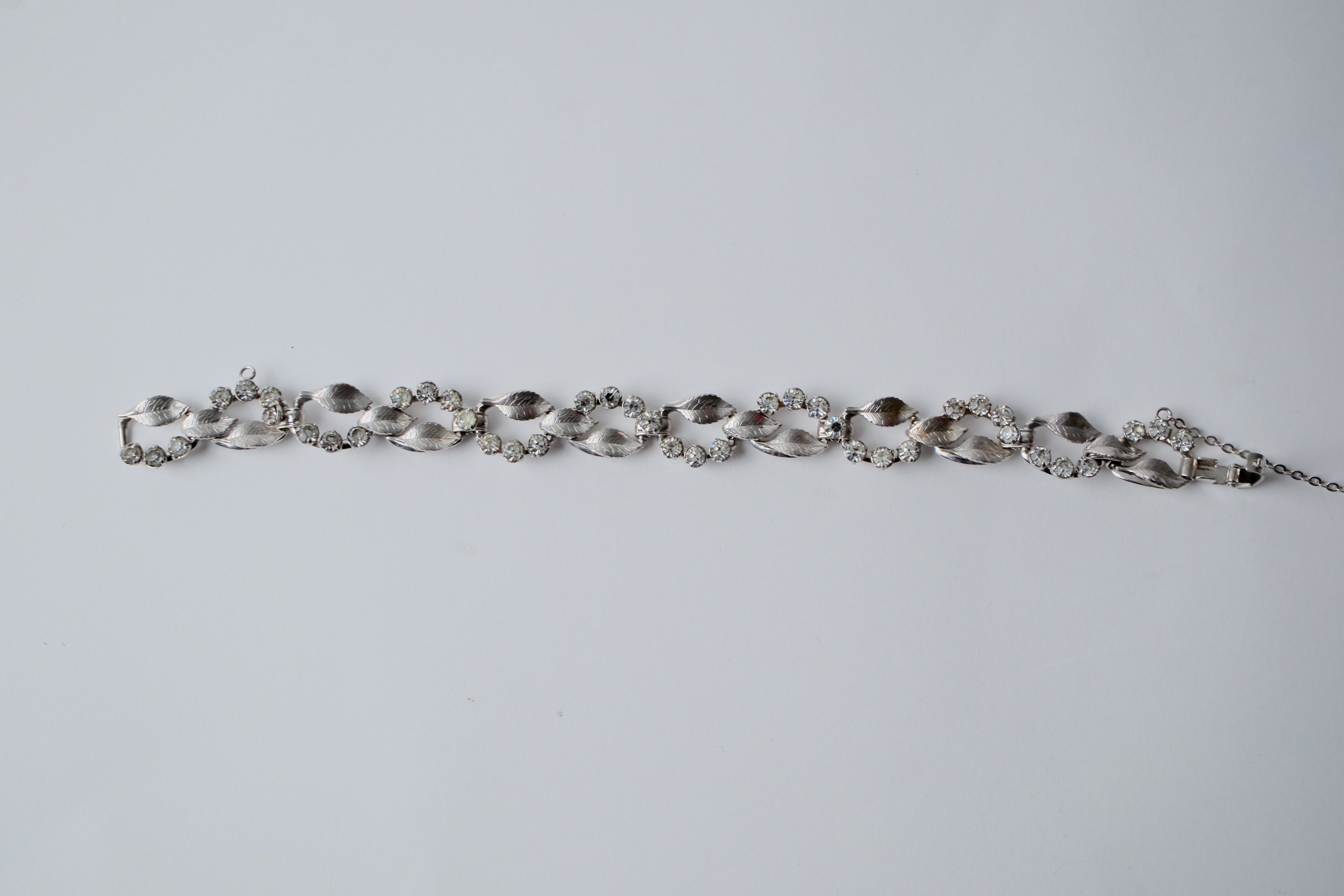 Vintage silver-tone bracelet with leaf design and rhinestones