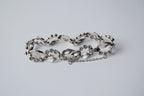 Vintage silver-tone bracelet with leaf design and rhinestones
