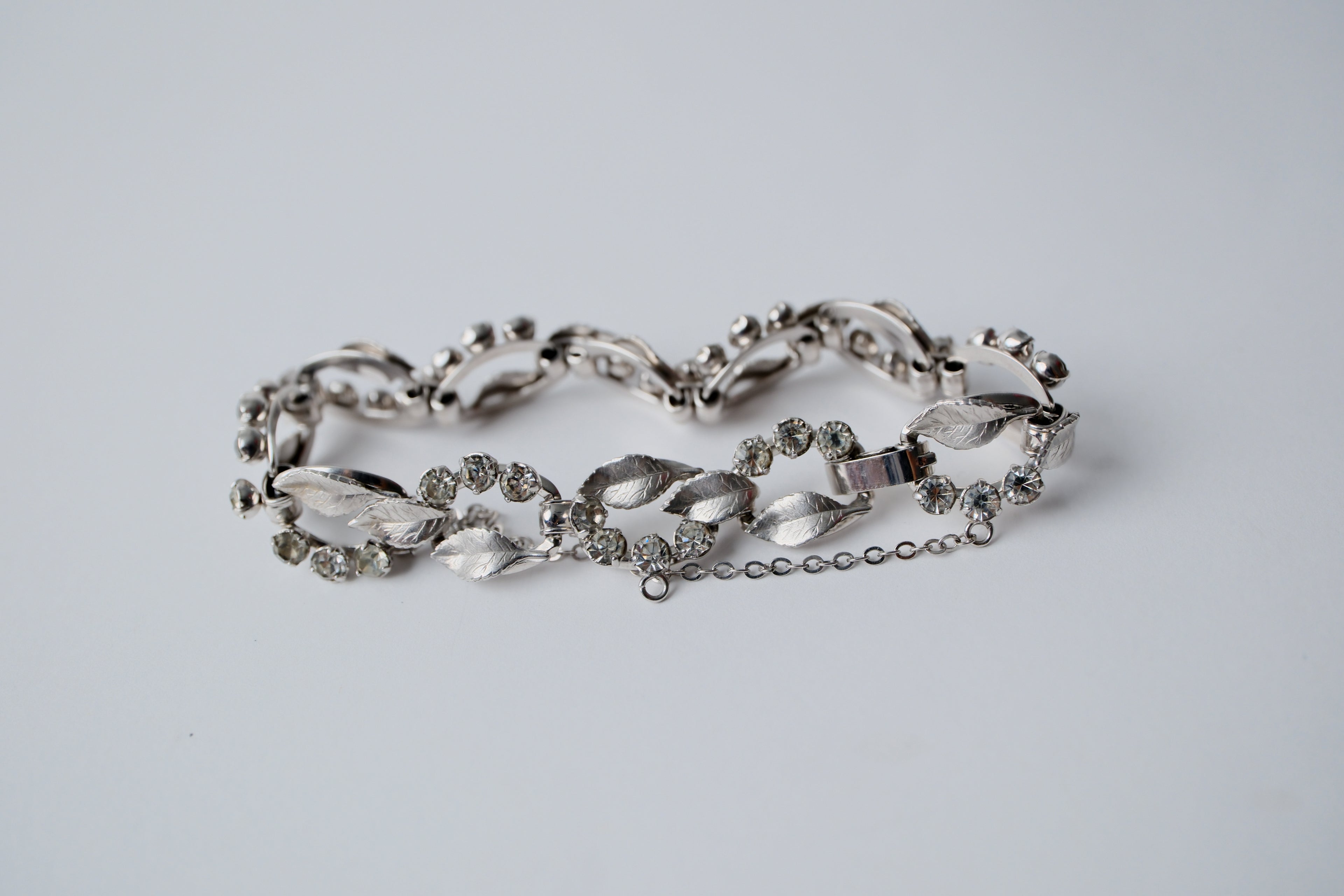 Vintage silver-tone bracelet with leaf design and rhinestones
