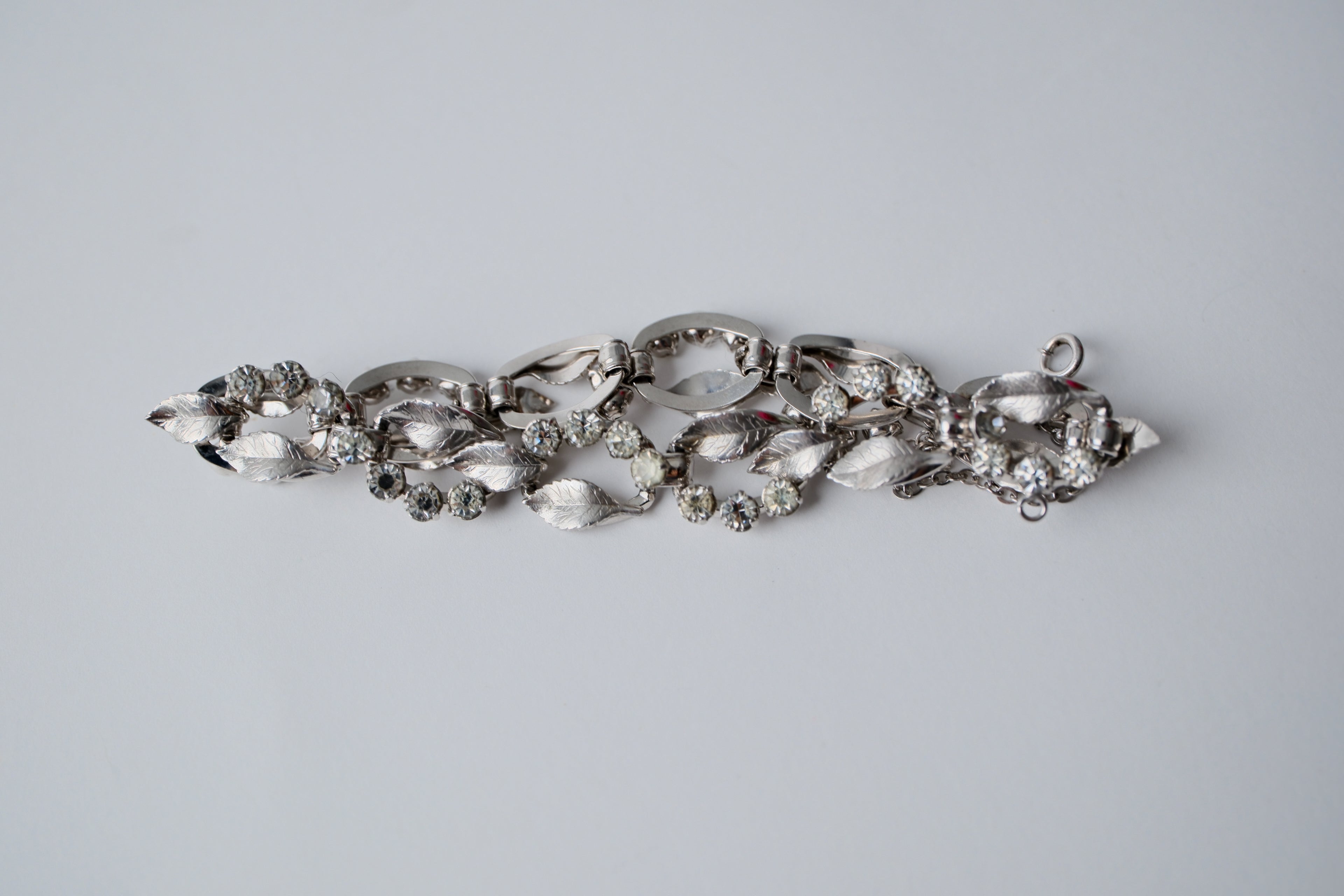 Vintage silver-tone bracelet with leaf design and rhinestones