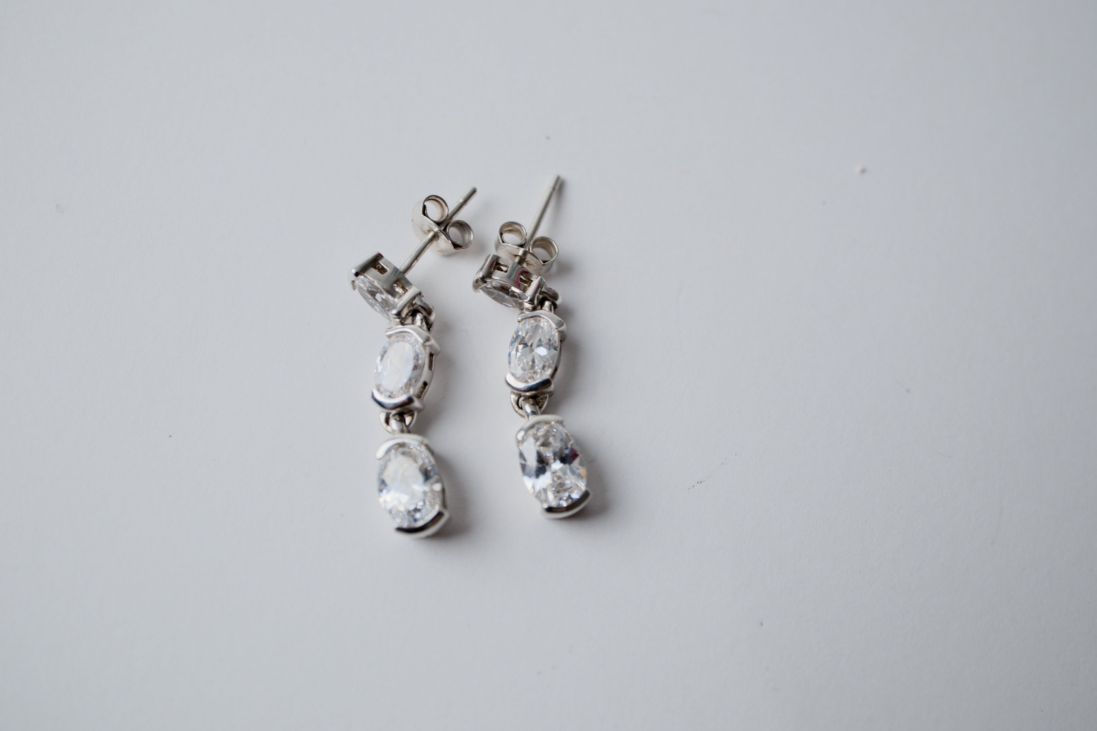 Sterling silver three-stone oval drop earrings