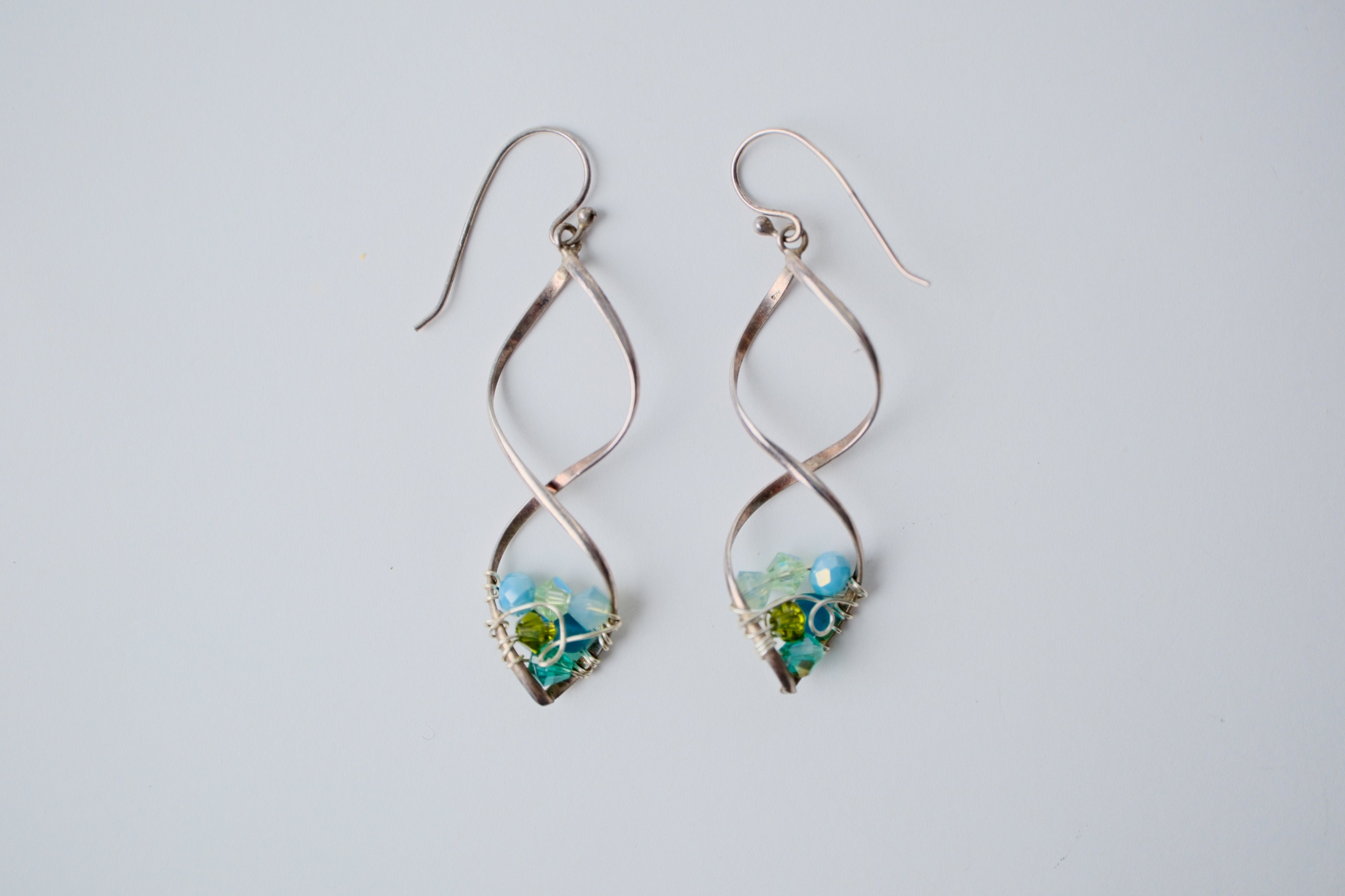 Sterling silver spiral wire earring with multi-blue beads