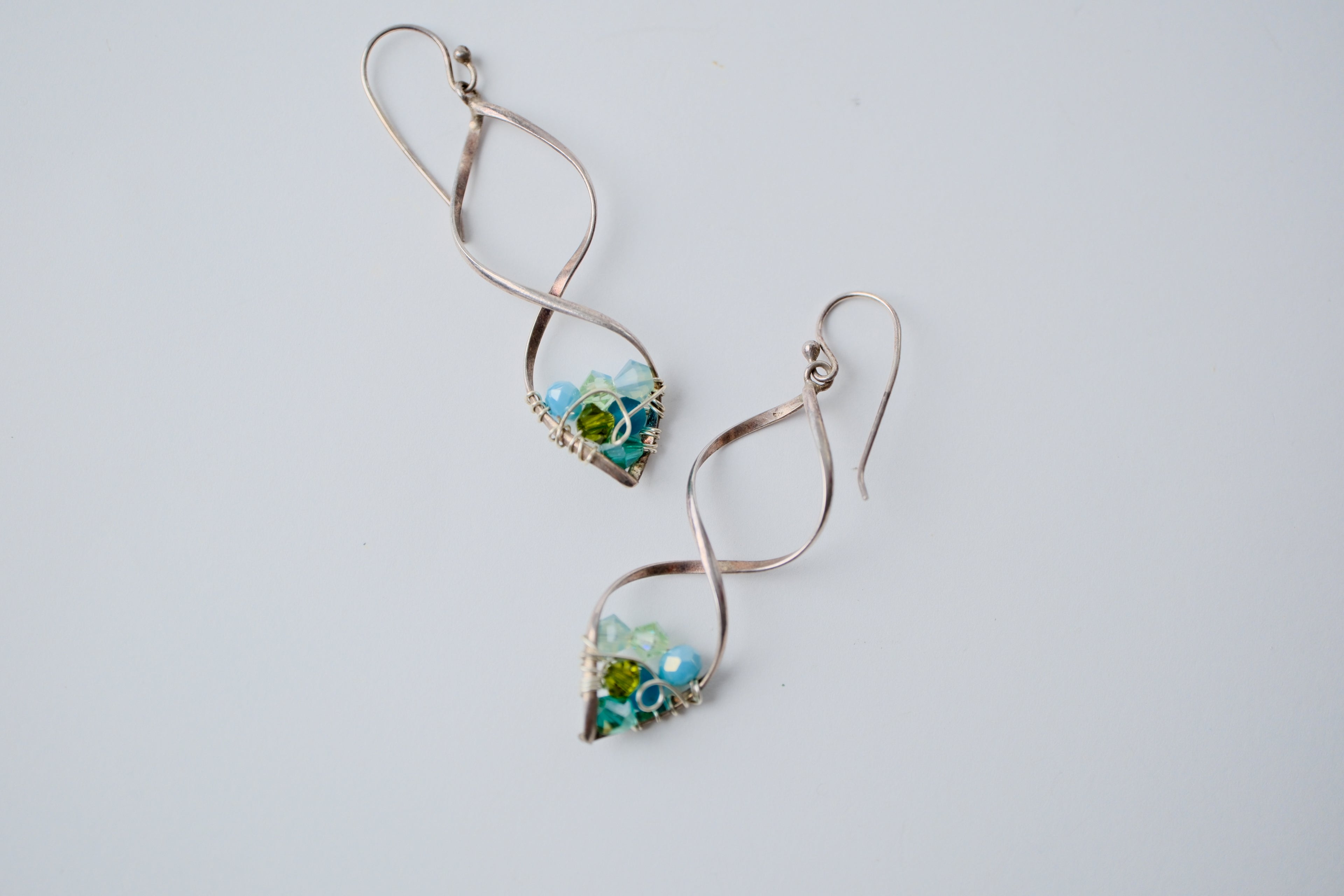Sterling silver spiral wire earring with multi-blue beads