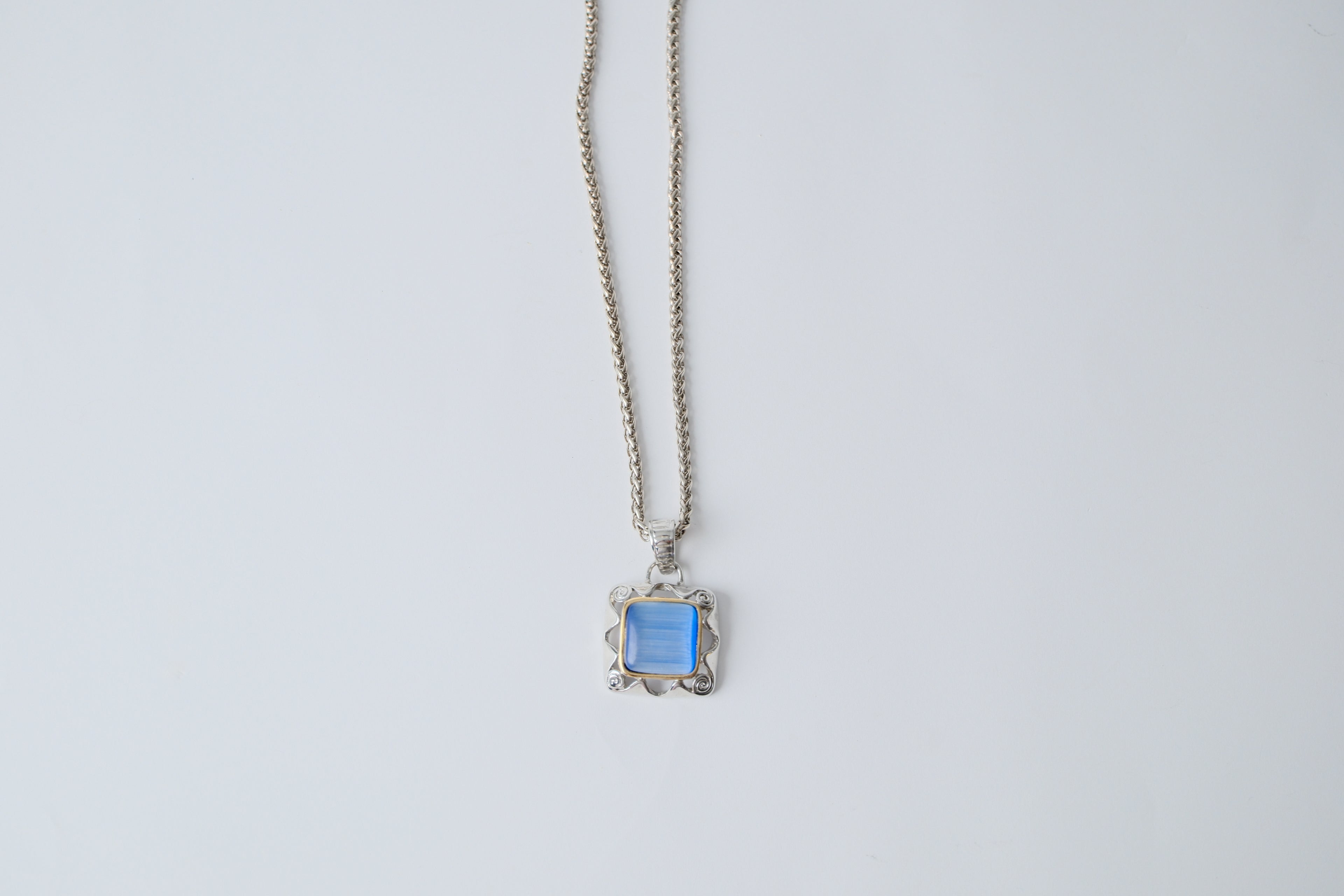 Silver toned chain with translucent blue stone