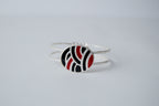 Red and black geometric pattern on a silver band