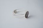 Red and black geometric pattern on a silver band