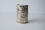 Ornate silver cuff bracelet with a floral design