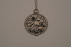 Antiqued silver-tone floral pendant